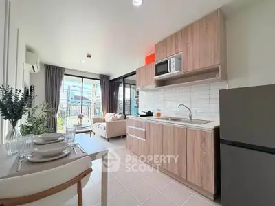 Modern open-plan kitchen and living room with natural light and stylish decor