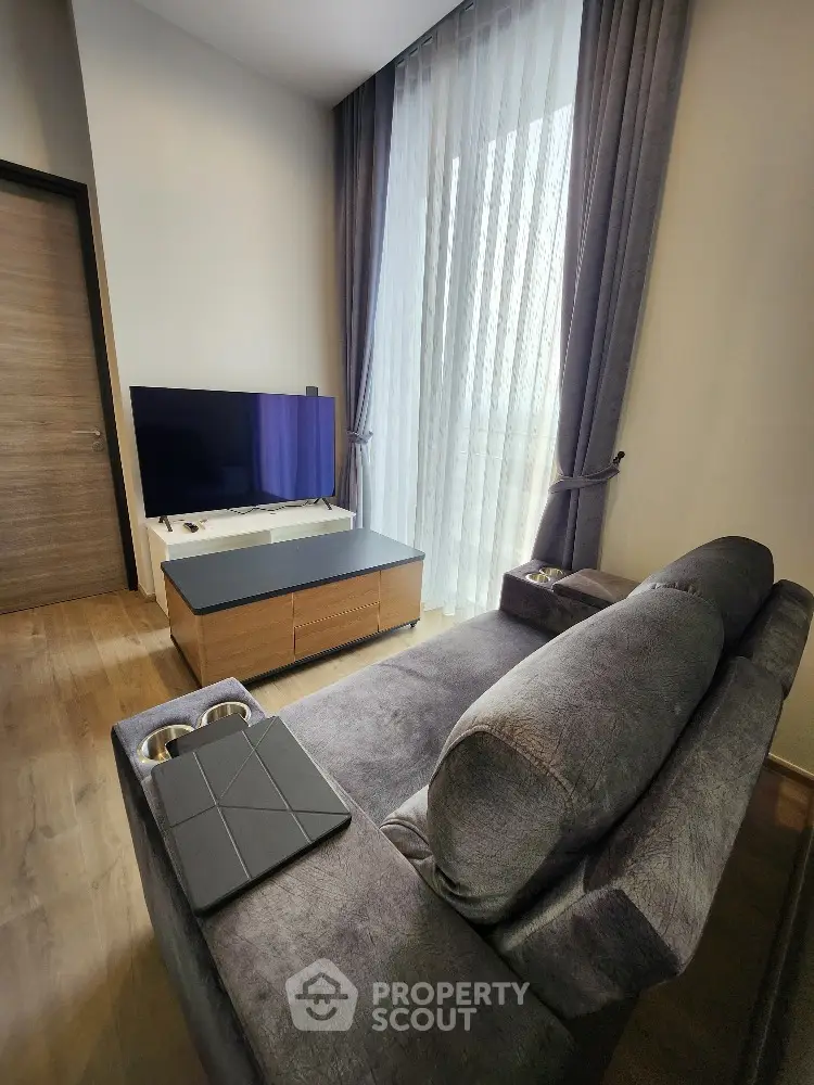 Modern living room with plush sofa and large window
