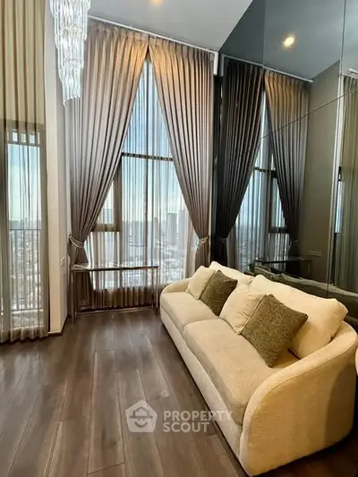 Luxurious high-ceiling living room with elegant drapes and plush sofa