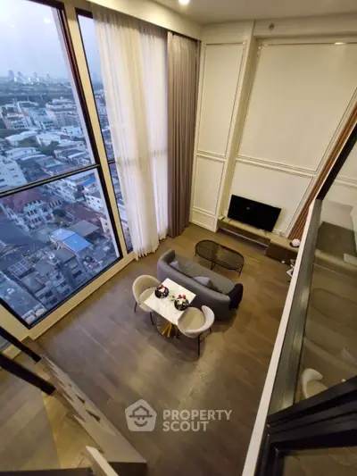 Stunning high-rise living room with panoramic city view and elegant decor.