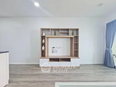 Modern living room with stylish wooden shelving unit and elegant decor