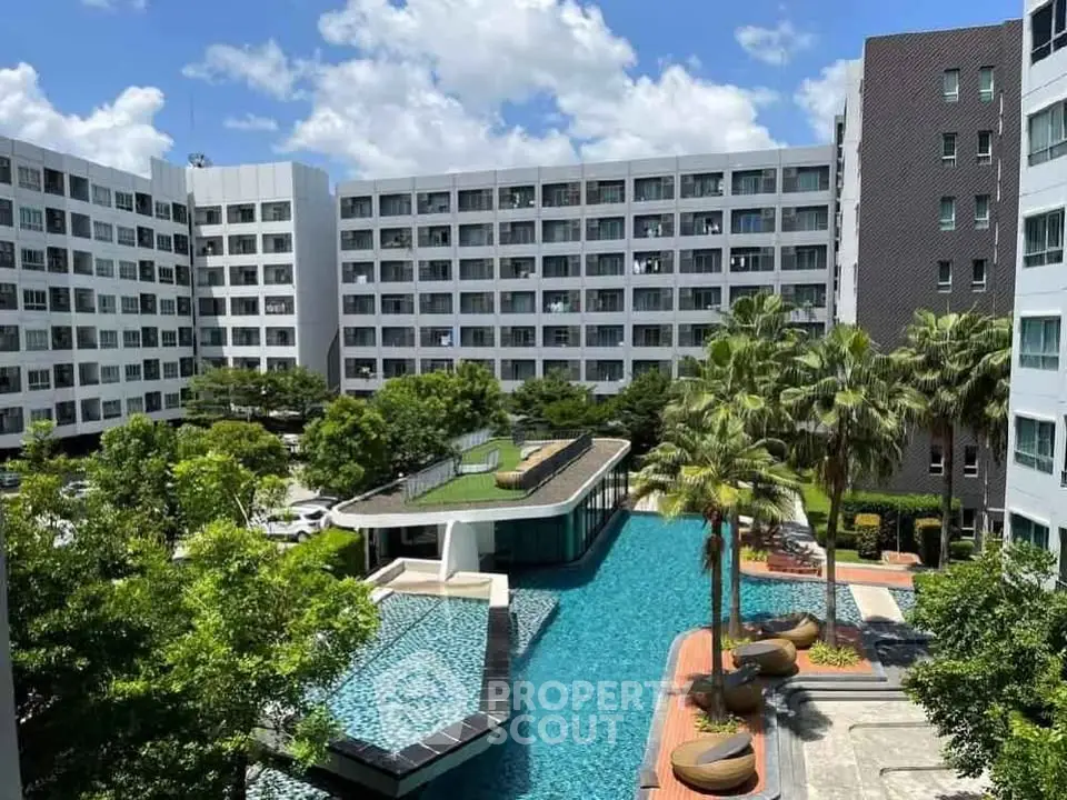Luxurious condominium with stunning pool and lush greenery in modern urban setting.
