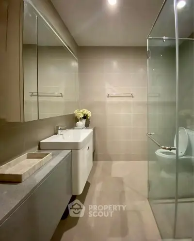 Modern bathroom with glass shower and sleek vanity design