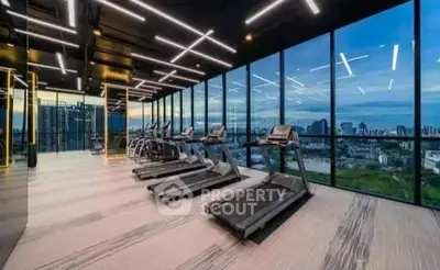 Luxurious high-rise gym with panoramic city views and modern equipment.