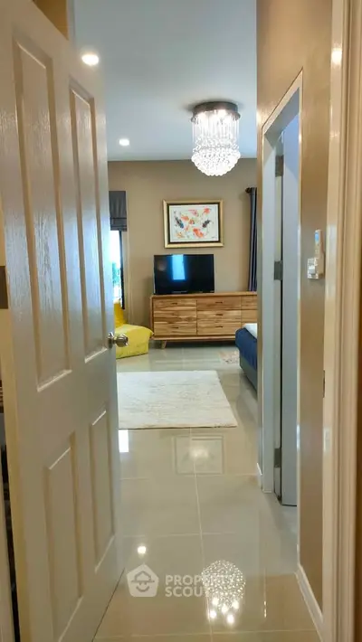 Stylish living room with modern decor and elegant chandelier in a cozy apartment.