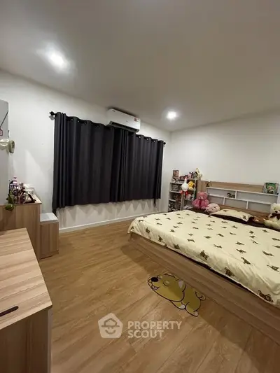 Cozy bedroom with wooden flooring and stylish decor