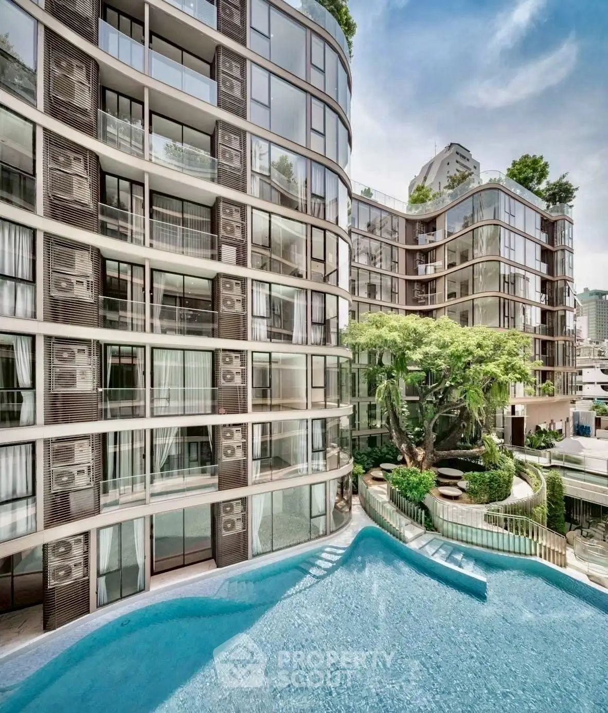 Luxurious modern apartment complex with stunning pool and lush greenery