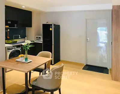 Modern kitchen and dining area with sleek appliances and stylish decor