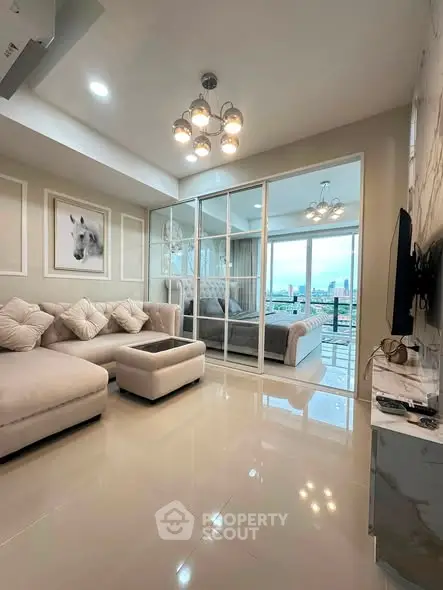 Luxurious modern living room with elegant decor and city view, featuring plush seating and stylish lighting.