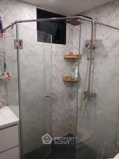 Modern bathroom with glass shower enclosure and stylish tile design