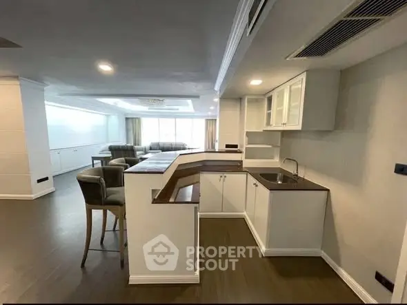 Spacious open-layout kitchen with modern design and adjacent living area