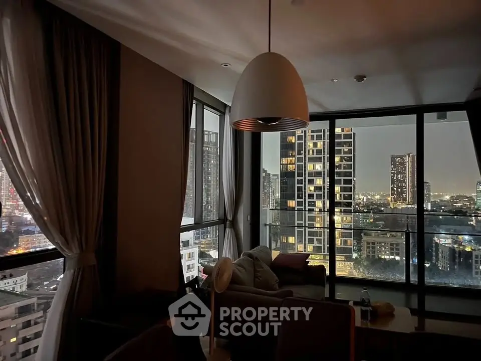 Stunning city view from modern living room with floor-to-ceiling windows and elegant lighting.
