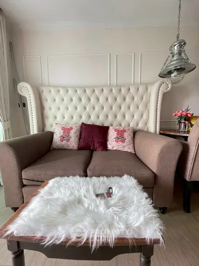 Charming living room with elegant sofa and plush decor accents