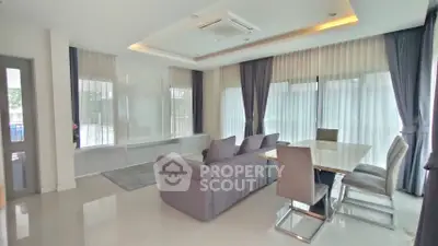 Spacious modern living room with elegant dining area and large windows