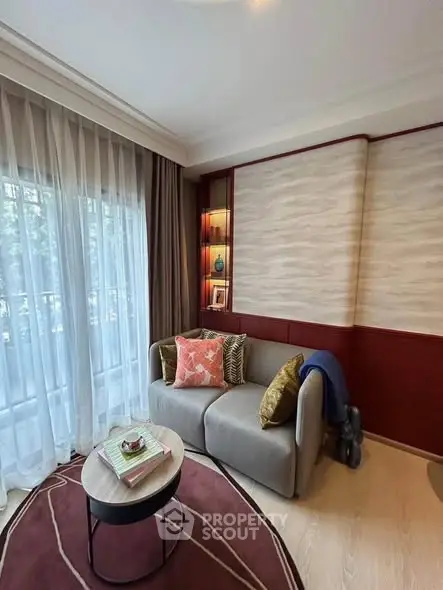 Cozy living room with elegant decor and natural light, featuring a stylish sofa and modern coffee table.