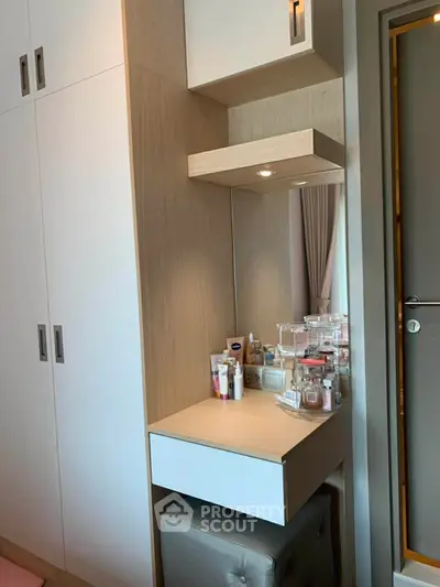 Modern bedroom with stylish vanity and ample storage space