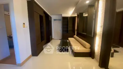 Modern living room with sleek dark wood furniture and ambient lighting