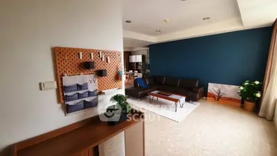 Spacious living room with modern decor and stylish blue accent wall