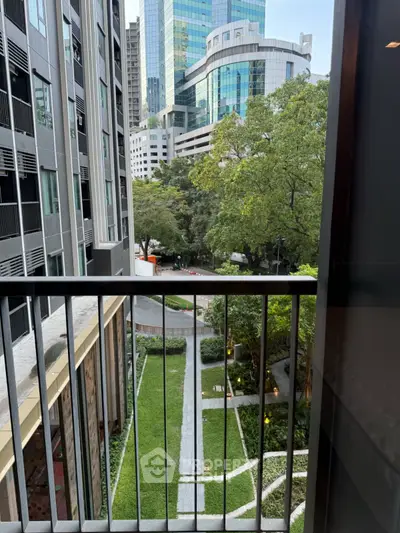 Urban apartment balcony with city view and lush garden below