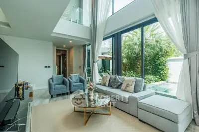 Luxurious living room with high ceilings and garden view