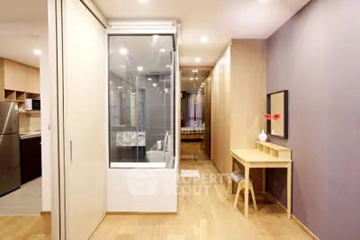 Modern apartment interior with open layout, featuring a stylish kitchen and cozy living area.
