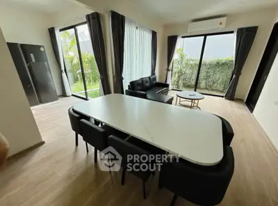 Spacious modern living room with garden view and elegant dining area