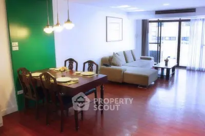 Spacious living room with elegant dining area and large windows for natural light.