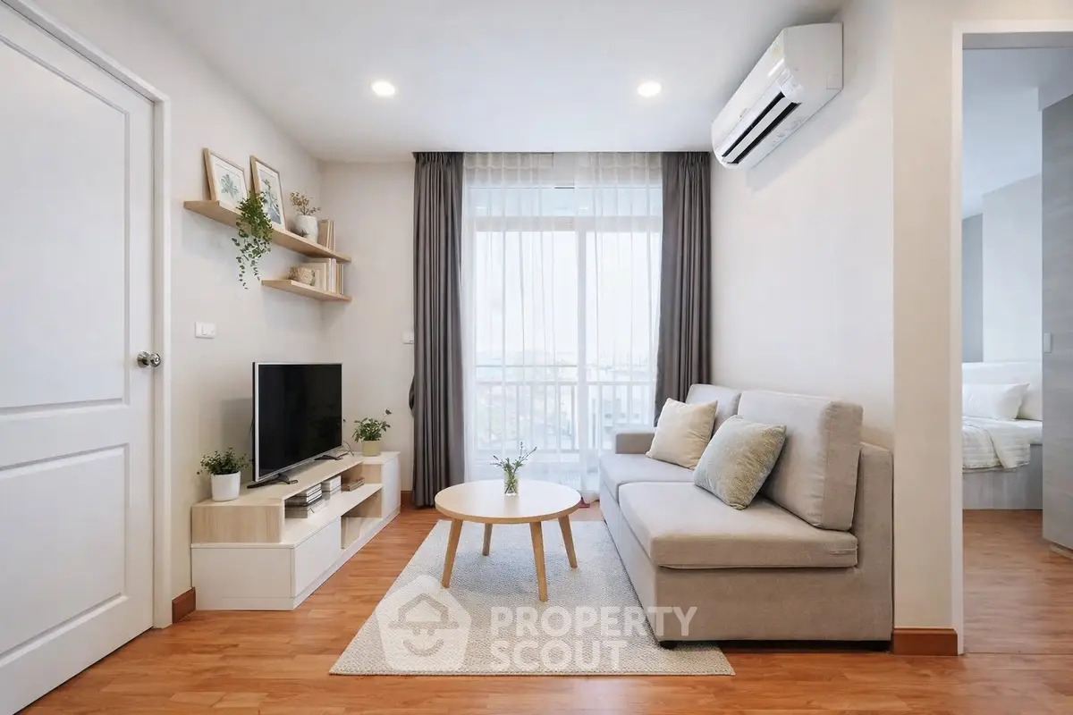 Modern living room with cozy sofa, TV, and air conditioning, featuring natural light and stylish decor.