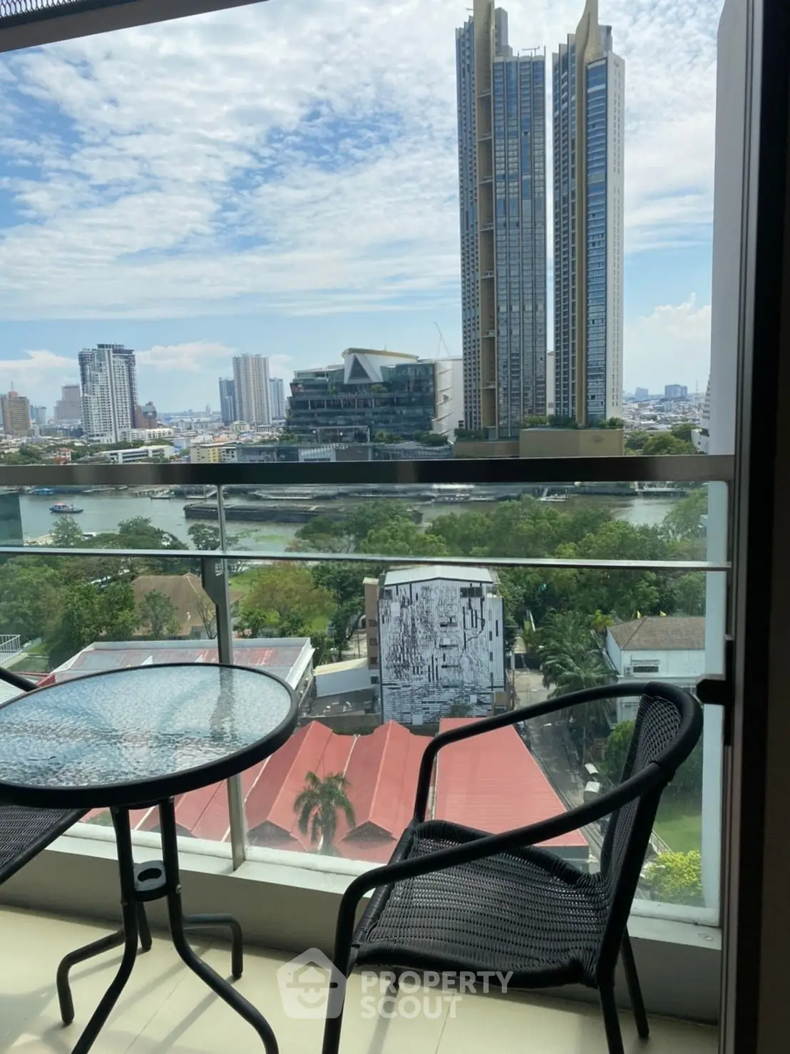 Stunning balcony view of city skyline and river, perfect for urban living.