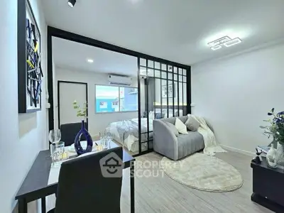 Modern open-plan living room with stylish decor and cozy seating area