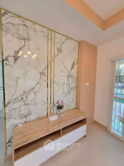 Elegant living room with marble accent wall and modern decor