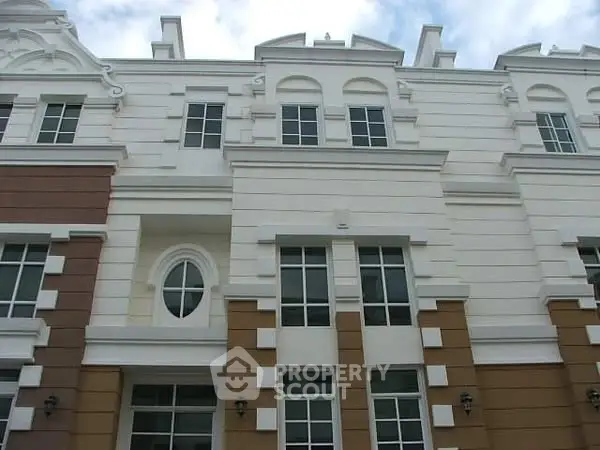 Elegant multi-story building with classic architectural design and large windows.