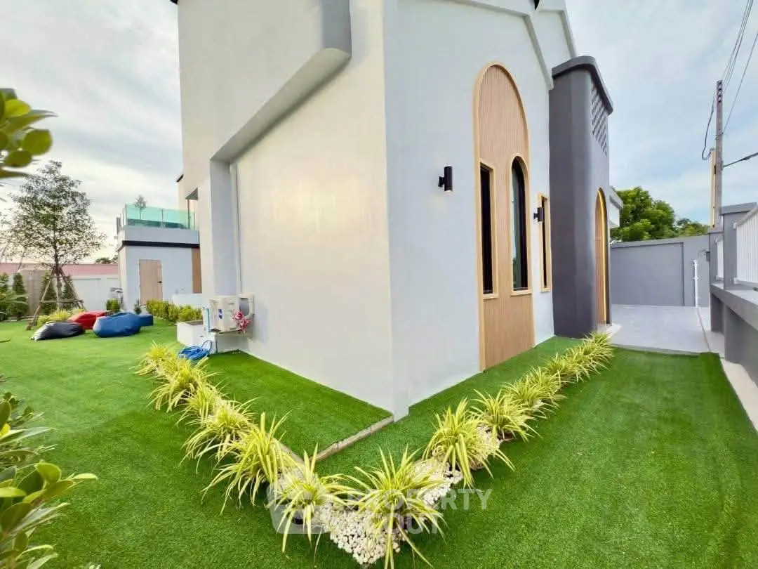 Modern house exterior with lush green lawn and stylish architecture