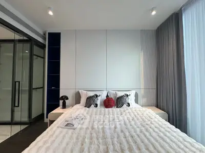 Modern bedroom with stylish decor and large window for natural light