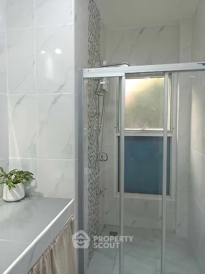Modern bathroom with glass shower and elegant tile design