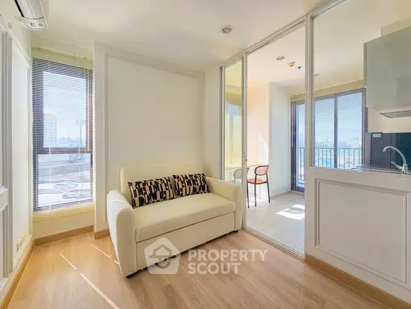 Bright modern living room with sliding glass doors and city view.