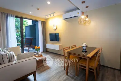 Modern living room with dining area and balcony view