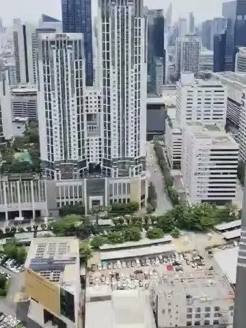 Stunning aerial view of modern high-rise buildings in a bustling urban cityscape.