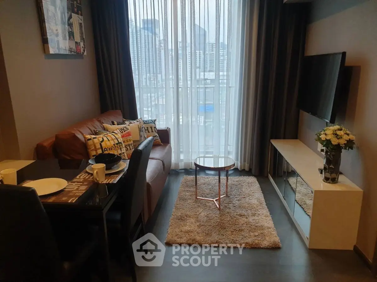 Modern living room with city view, cozy seating, and stylish decor in urban apartment.