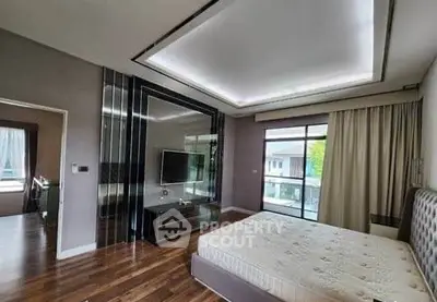 Spacious modern bedroom with large window and stylish decor