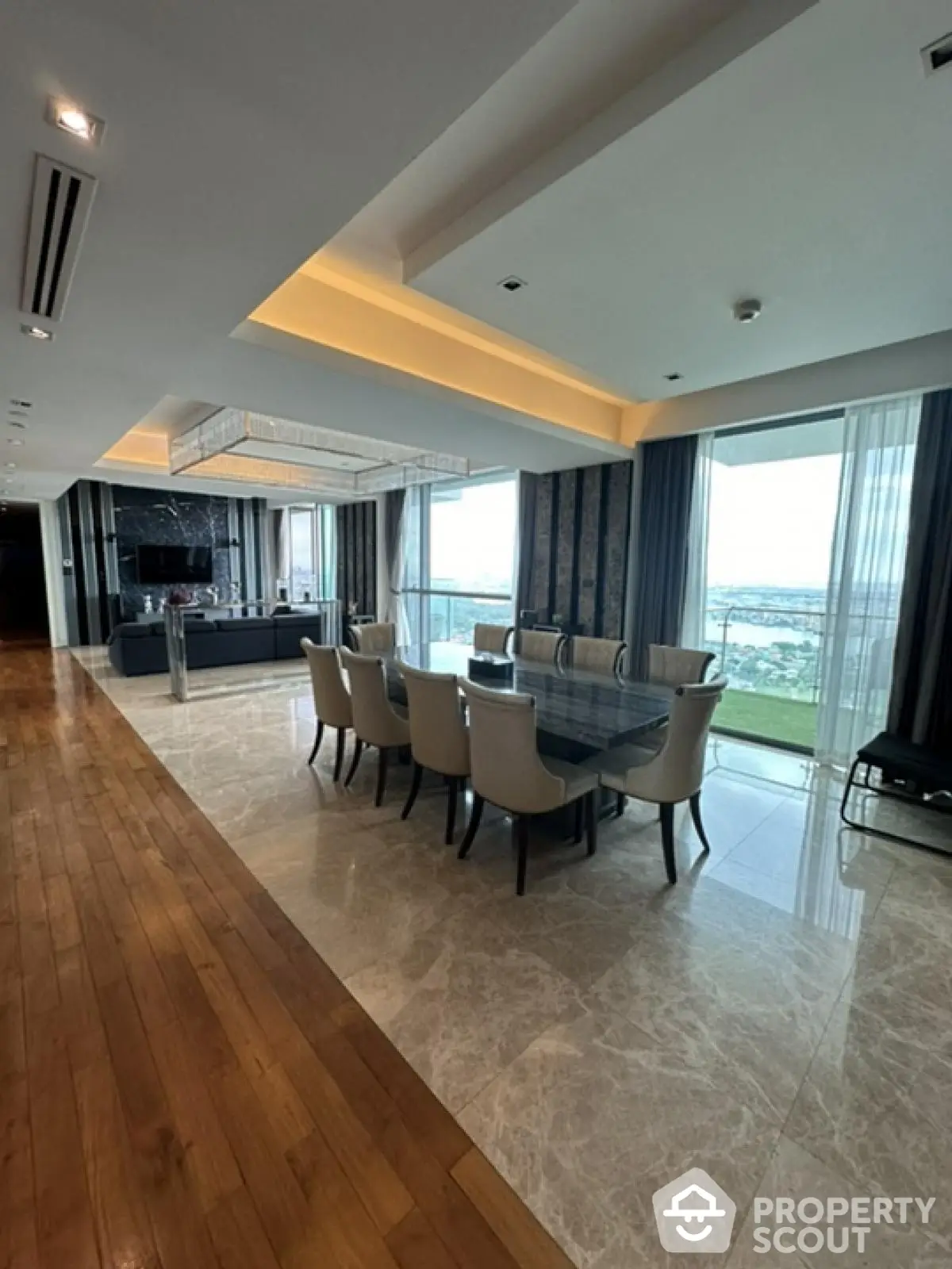 Luxurious open-plan living and dining area with stunning views and elegant decor.