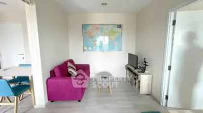 Charming living room with vibrant pink sofa and world map decor, perfect for cozy relaxation.