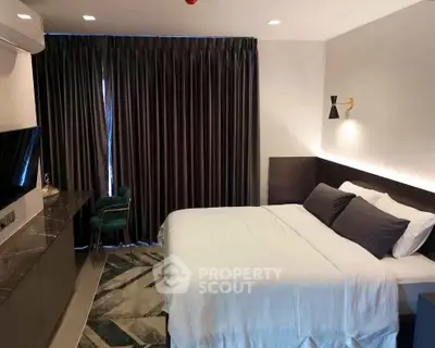 Modern bedroom with elegant decor and cozy ambiance in a stylish apartment.