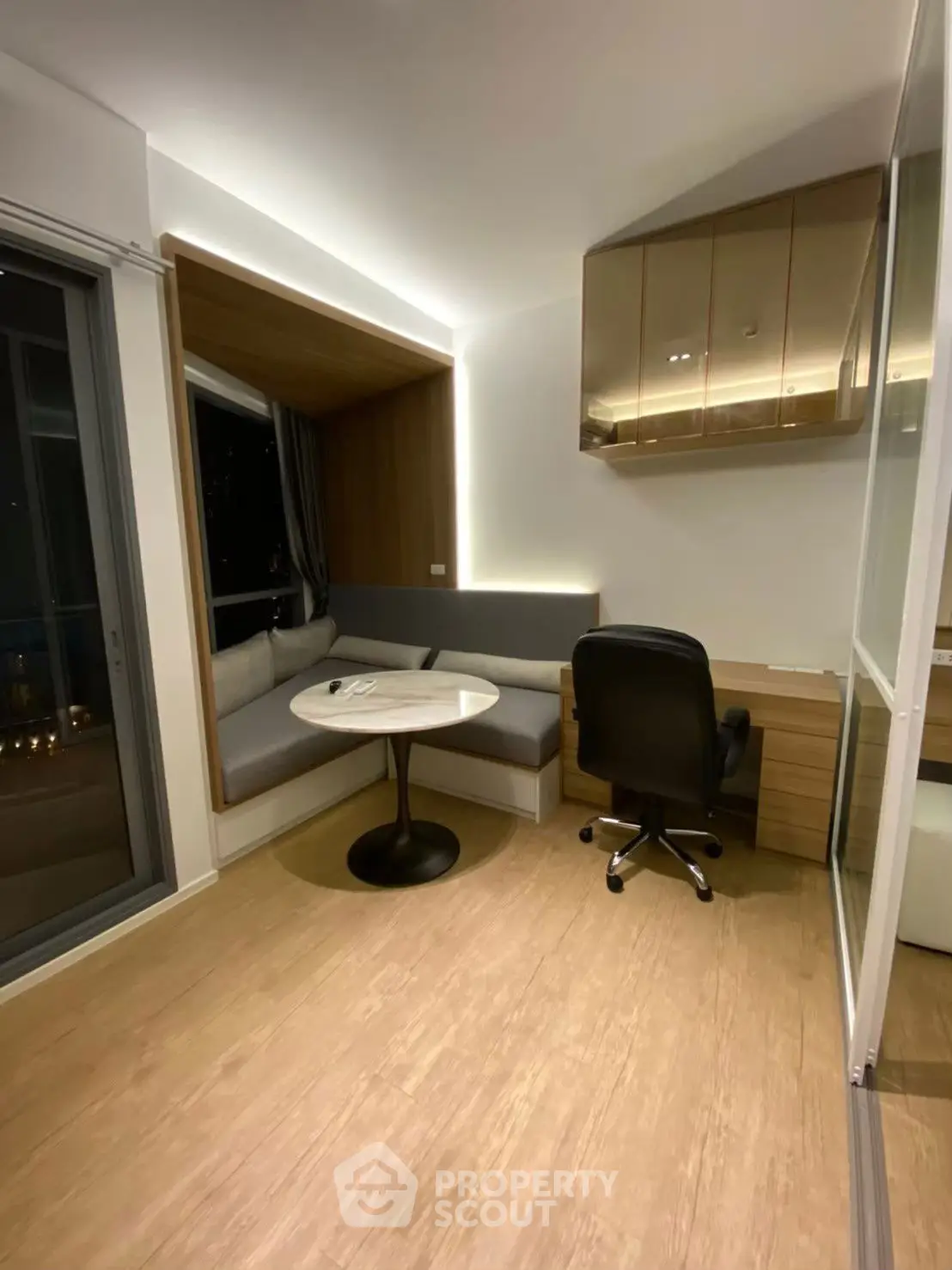 Modern study room with built-in seating and sleek desk in a stylish apartment