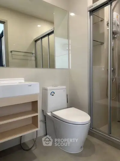 Modern bathroom with sleek fixtures and glass shower enclosure