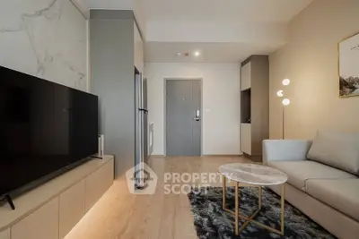 Modern living room with sleek design, featuring a cozy sofa, stylish TV setup, and elegant lighting.