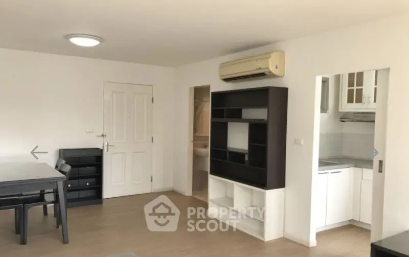 Spacious living room with modern furniture and open kitchen layout