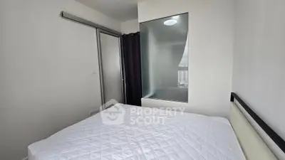 Modern minimalist bedroom with large window and sleek design