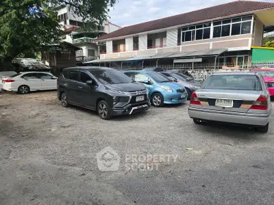 Spacious parking area with multiple cars in a residential neighborhood.