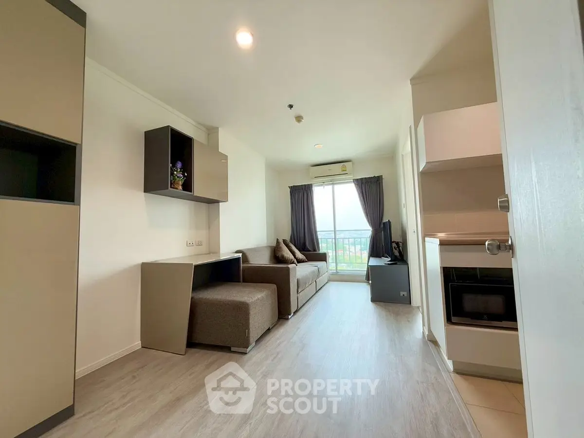 Modern living room with sleek furniture and balcony view, perfect for urban living.